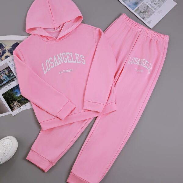 Adorable girl wearing a playful spring hues hooded sports suit, featuring a charming cartoon print. Perfect for spring adventures!