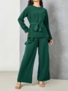 Sand colored polyester two piece pant set featuring a relaxed top and wide leg pants Model poses effortlessly chic