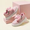 Pink and white girls princess sneakers with bows and heart accents showcasing their sparkly design and comfortable features Perfect for spring fall school or playdates