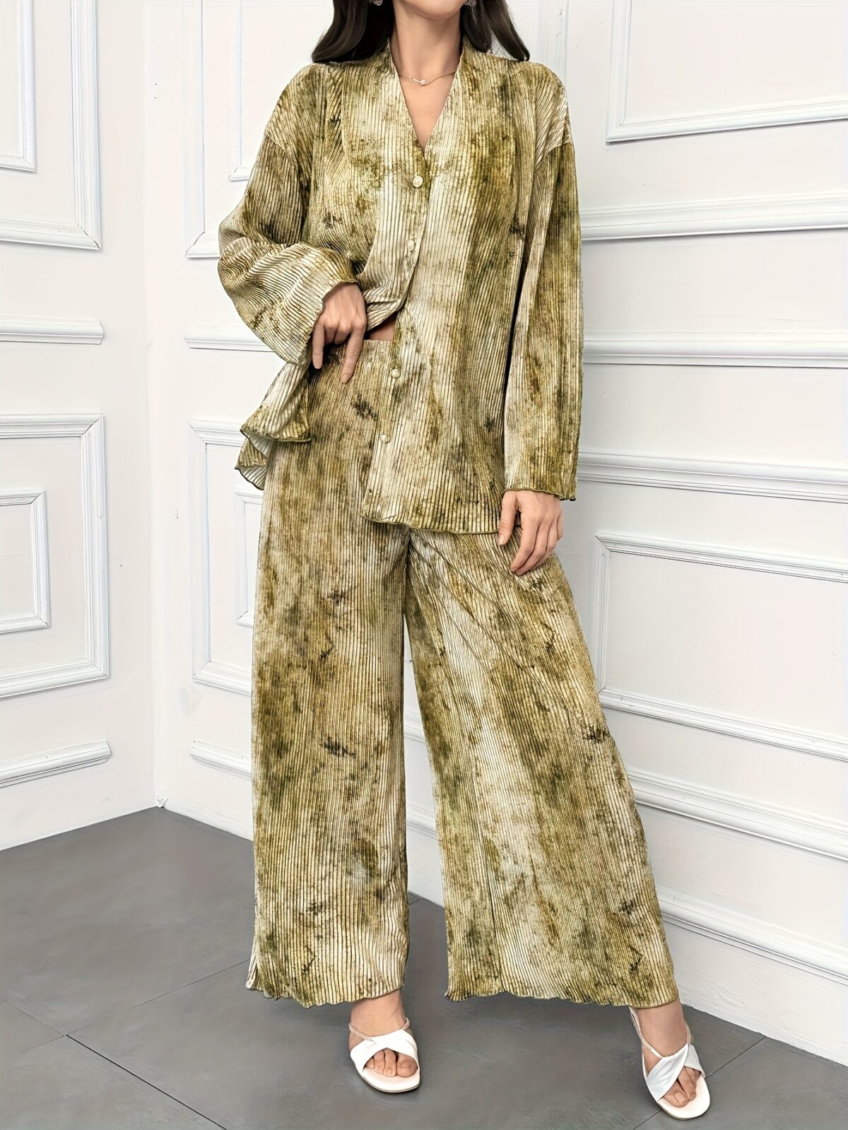 Model showcasing the Newness Effortless Chic Tie Dye Pantsuit a stylish spring ensemble featuring a vibrant tie dye pattern on both the pants and matching blazer The pantsuit exudes effortless sophistication and chic style