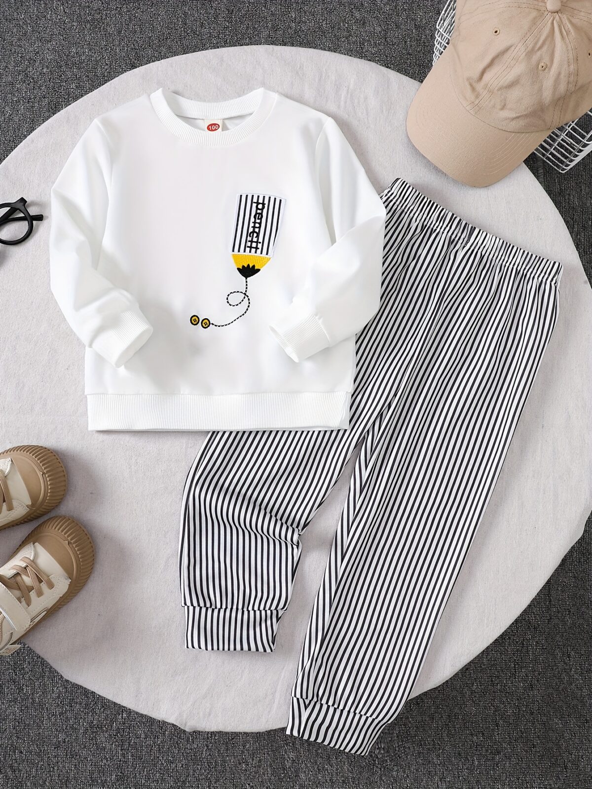 Adorable boys hoodie and sweatpants set featuring a stylish pencil pattern hoodie and comfortable striped sweatpants Perfect for school playdates or cozy days at home
