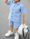 Adorable boy playing outdoors wearing the Newness Summer Breeze Boys Casual Short Set The set is comfortable and perfect for playtime