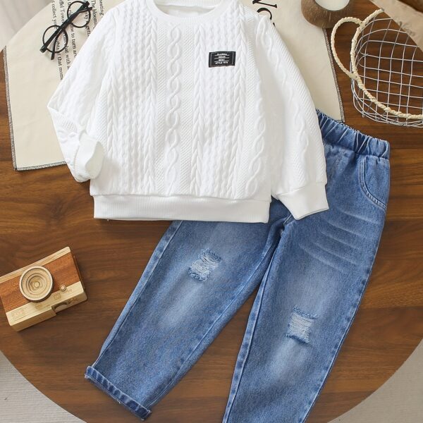 Stylish boy's outfit: long-sleeve solid color top and ripped faux denim jeans, perfect for spring and fall.
