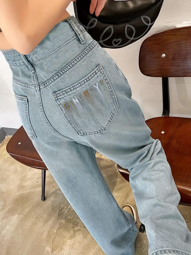 Model wearing Newness' Dubai Nights High-Waist Wide-Leg Jeans, showcasing the flattering high waist and wide-leg silhouette. The jeans are a versatile dark wash, perfect for both day and night.