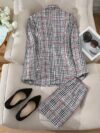 Model showcasing the Newness Kensington Plaid Skirt Set a chic and modern take on the classic plaid skirt set Featuring a stylishly tailored skirt and coordinating top