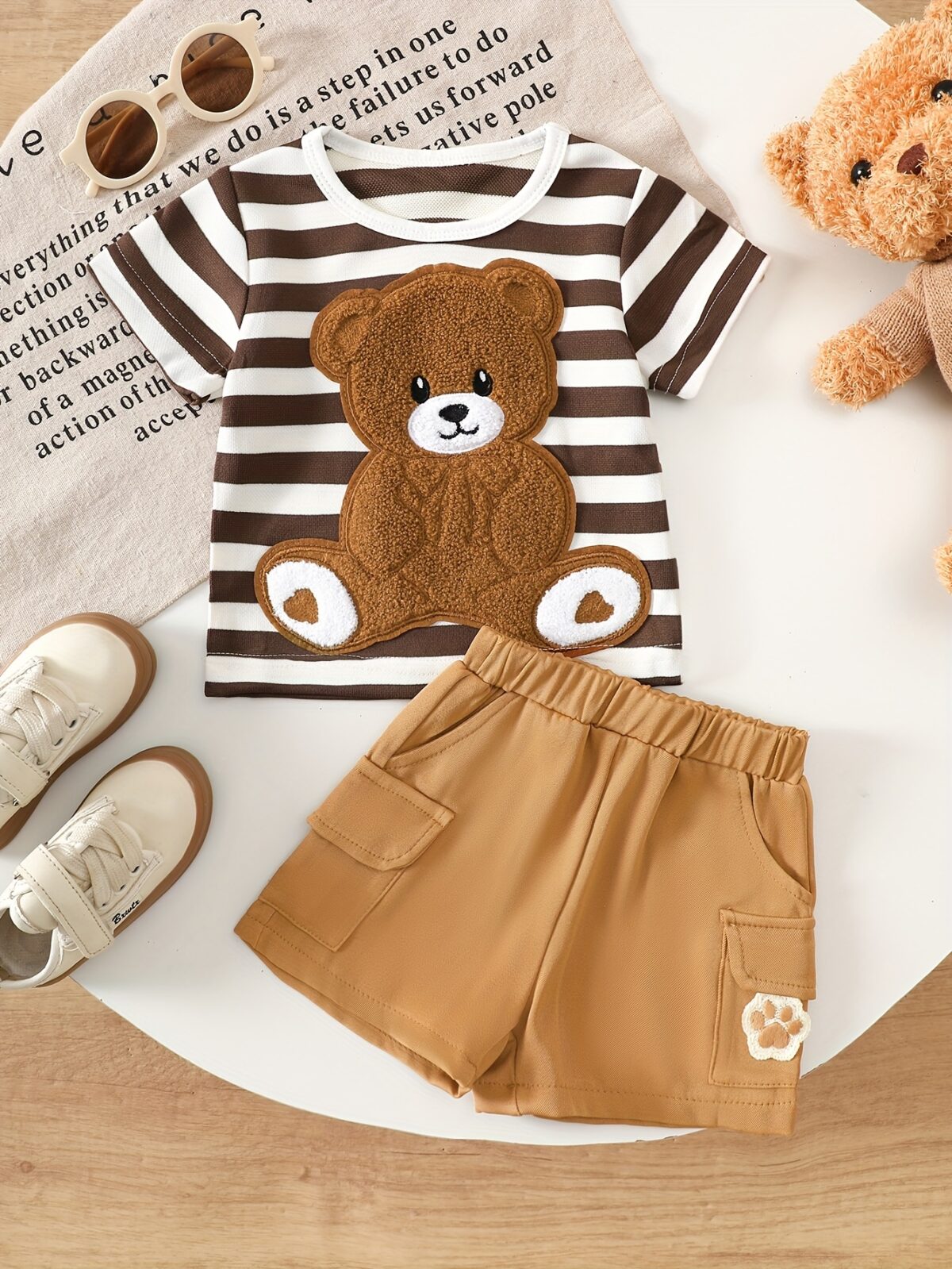 Adorable baby boy wearing Newness Cozy Cub Two Piece Set featuring a striped top with bear embroidery and matching shorts Perfect for spring and summer