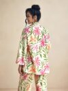 Model wearing the Newness Summer Escape Tropical Print Suit a vibrant and chic outfit perfect for beach vacations and beyond