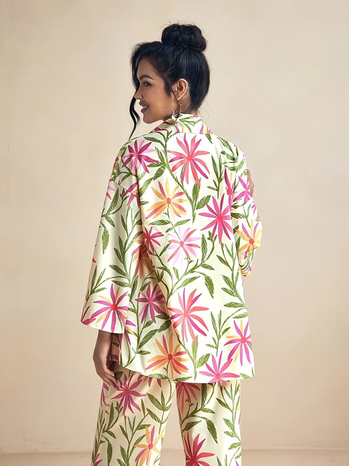 Model wearing the Newness Summer Escape Tropical Print Suit a vibrant and chic outfit perfect for beach vacations and beyond