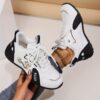 Newness Nova Minimalist White Sneakers A pair of sleek white minimalist sneakers showcasing comfort and versatility ideal for any occasion