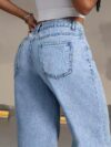 Model wearing Newness Dubai Breeze Wide Leg Jeans a light wash high waisted pair of wide leg jeans