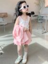Adorable girl wearing Newness Riviera Chic summer outfit a stylish and breathable dress perfect for sunny days