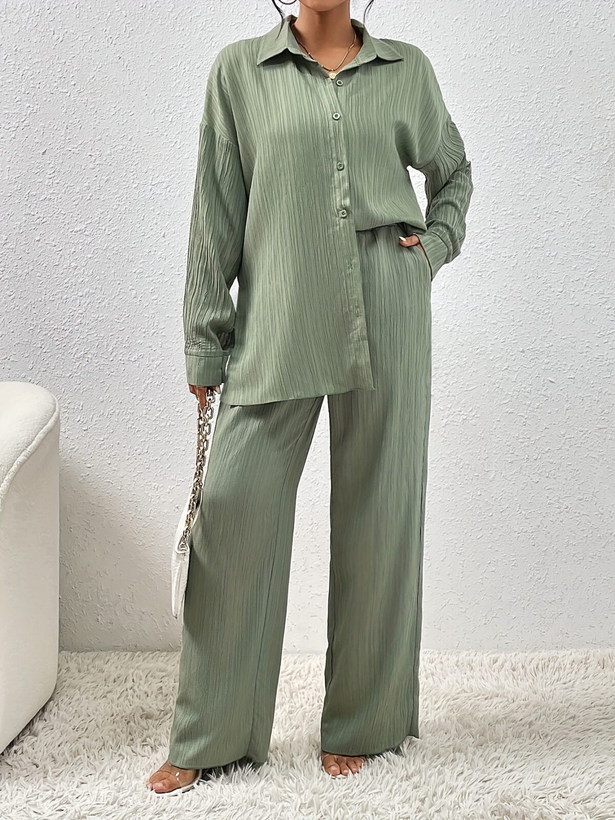 Model wearing the Newness Dubai Nights Off Shoulder Pants Set a luxurious polyester two piece outfit featuring an off shoulder top and wide leg pants perfect for evening events