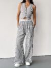 The Newness Riviera Striped Trouser Set in a flattering pose showcasing its relaxed fit and chic style Model is wearing the matching top and trousers