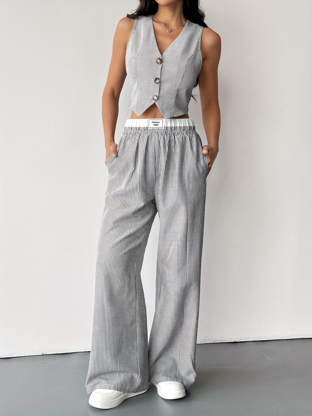 The Newness Riviera Striped Trouser Set in a flattering pose showcasing its relaxed fit and chic style Model is wearing the matching top and trousers