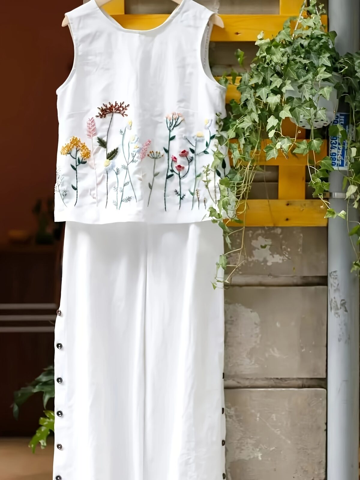 The Newness Botanical Embroidered Vest Suit in a flattering pose Showcasing the intricate embroidery and chic design