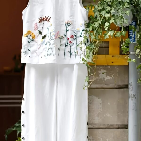 The Newness Botanical Embroidered Vest Suit in a flattering pose Showcasing the intricate embroidery and chic design