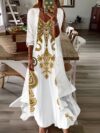 Stylish woman wearing the Newness Dubai Escape Paisley Vacation Dress Set posing against a backdrop of a luxurious Dubai hotel or resort The dress is a vibrant paisley print flowing elegantly