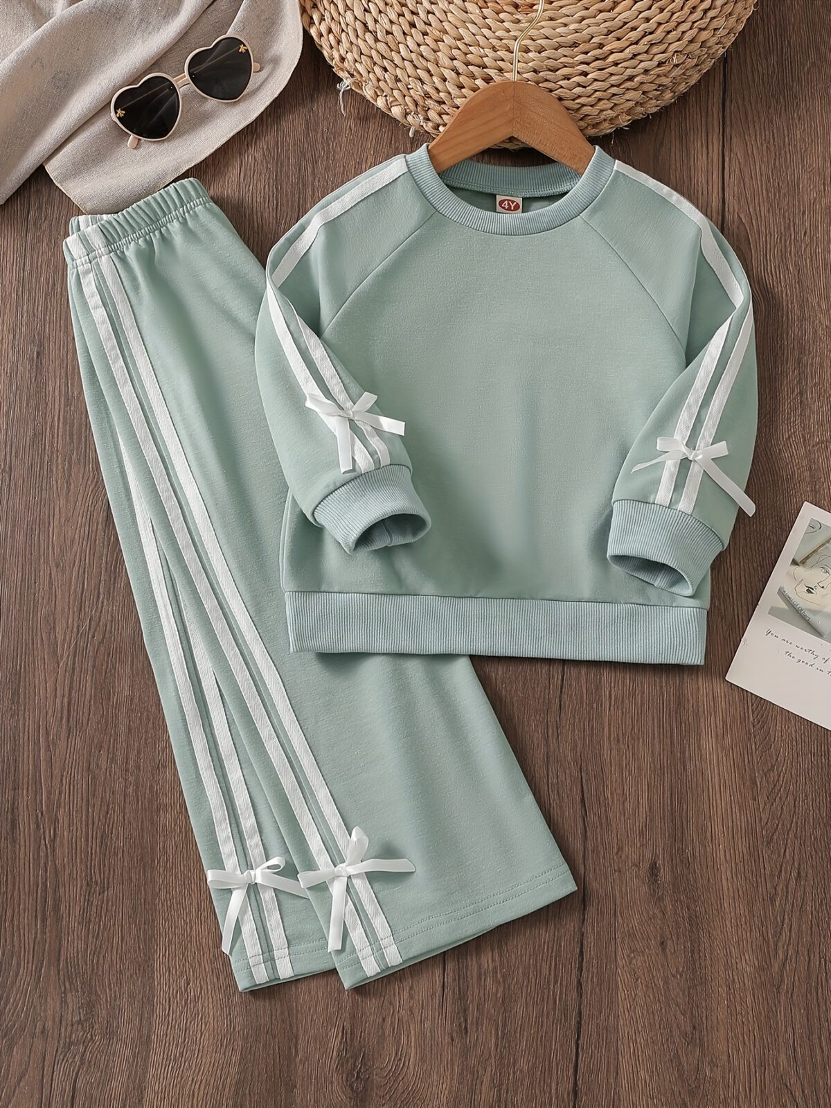 Girl wearing a stylish and comfortable two piece sweatpants set in soft stretchy fabric Perfect for everyday wear