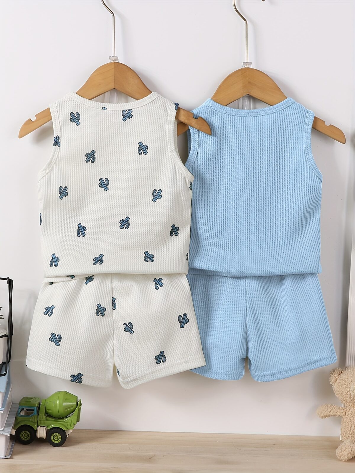 Adorable baby boy in a trendy Newness cactus print outfit featuring a waffle knit vest and pants Perfect summer clothes