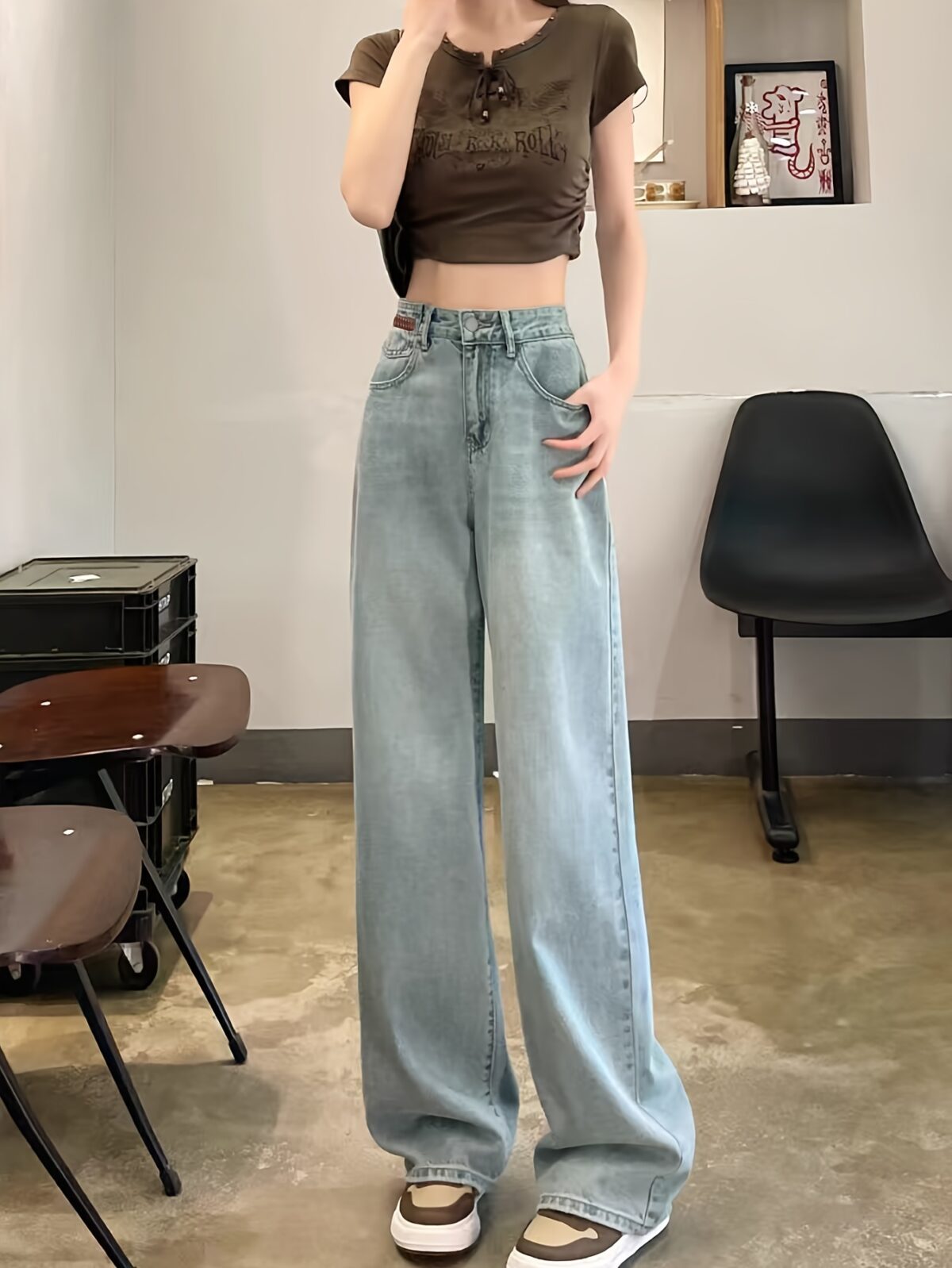 Model wearing Newness Dubai Nights High Waist Wide Leg Jeans showcasing the flattering high waist and wide leg silhouette The jeans are a versatile dark wash perfect for both day and night