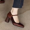 Elegant brown and white vintage style block heel pumps with ankle strap square toe and rubber sole