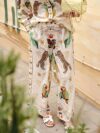 Embrace effortless chic in the Newness Escape to Paradise Tropical Print Pantsuit This vibrant pantsuit perfect for vacations and summer days features a stunning tropical print