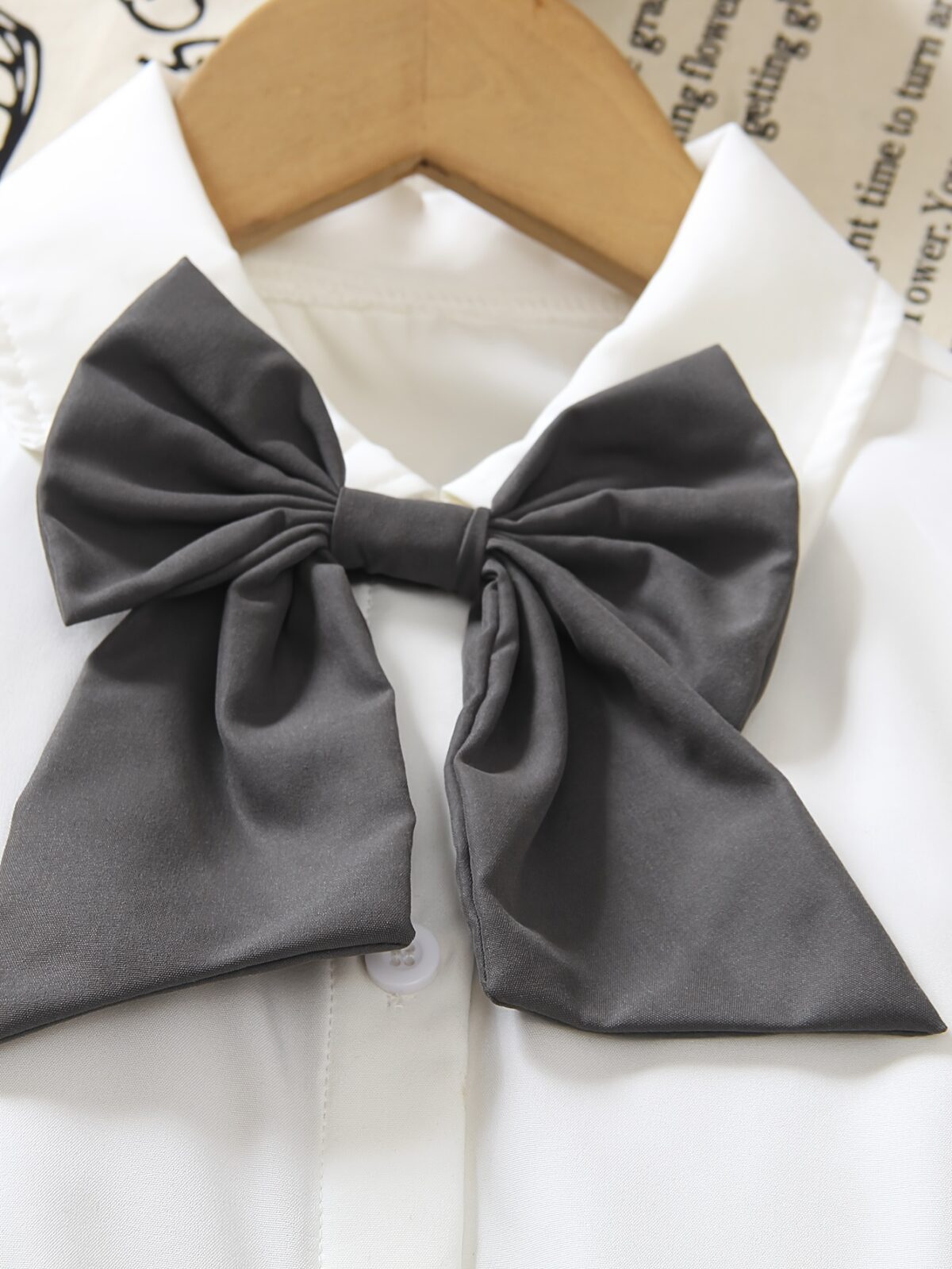 A charming little girl in a classic schoolgirl outfit smiling and playful Newness