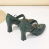 A pair of retro style embroidered womens high heel shoes in a pointed toe design