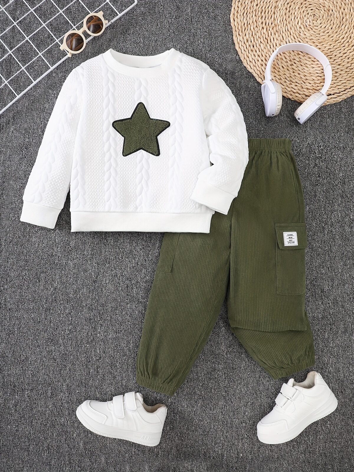Adorable boy modeling the Newness Cozy Comrade 2 Piece Set featuring a beige star embroidered sweatshirt and matching corduroy cargo pants Perfect for fall and winter