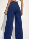 Model wearing Newness Dubai High Waisted Wide Leg Jeans a versatile pair of premium denim jeans in a flattering wide leg silhouette and high waisted fit perfect for any season