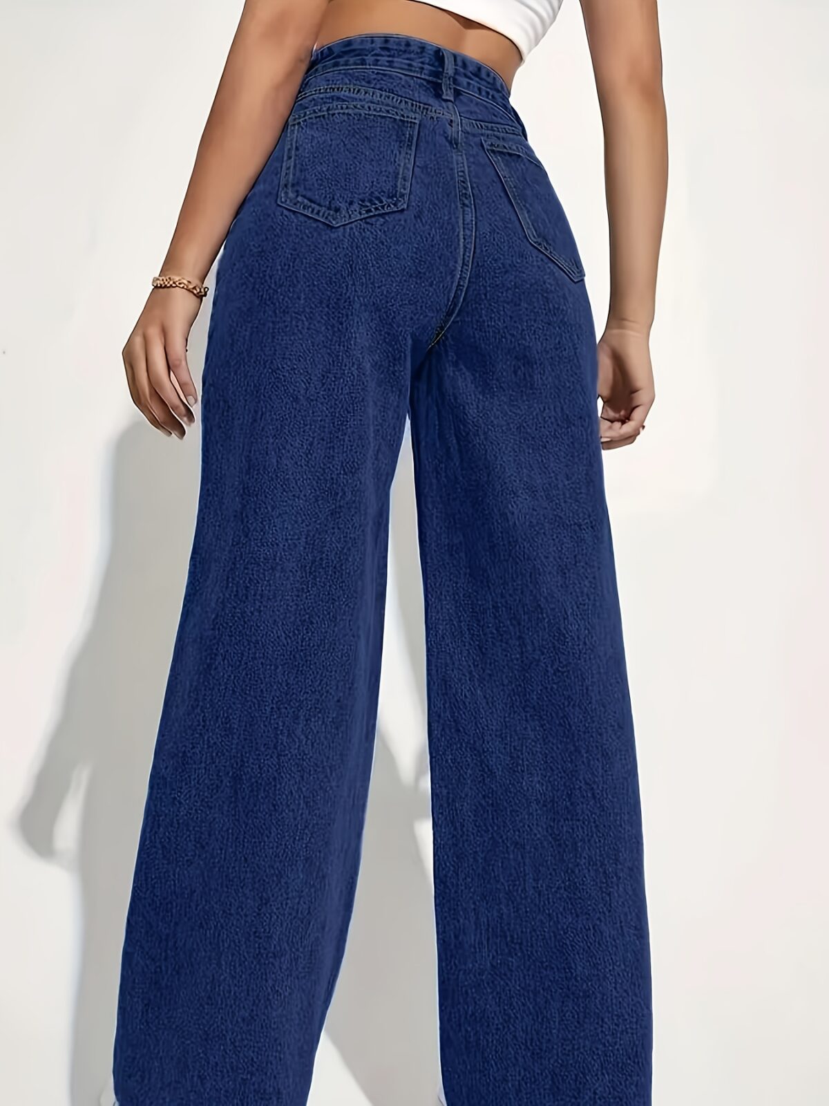 Model wearing Newness Dubai High Waisted Wide Leg Jeans a versatile pair of premium denim jeans in a flattering wide leg silhouette and high waisted fit perfect for any season