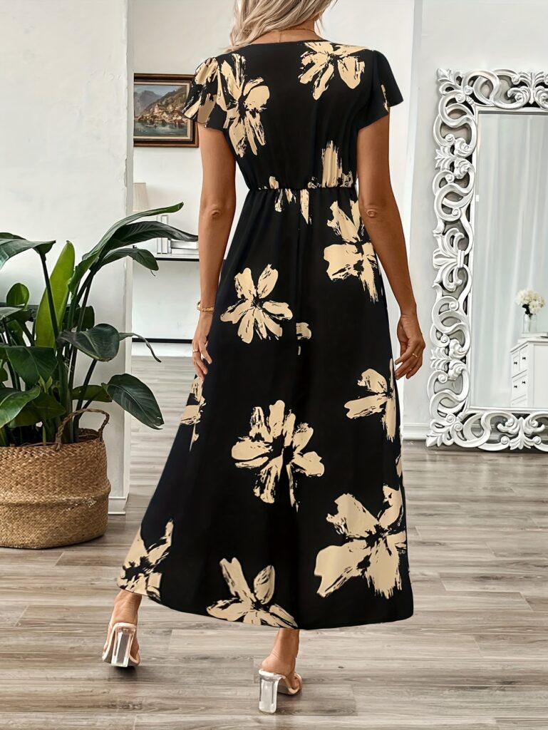 Black maxi dress with golden floral print, V-neckline, short sleeves, high waist, A-line silhouette, ruffled hemline.