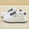 Womens white low top sneakers with red laces showcasing the side profile of the shoe