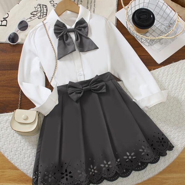 A charming little girl in a classic schoolgirl outfit smiling and playful Newness