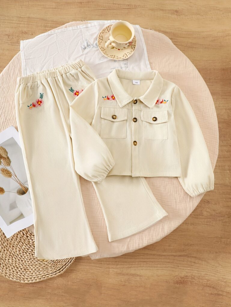 Adorable girl wearing the Newness Autumn Whisper Girls Corduroy Outfit, a stylish corduroy set perfect for fall. She's smiling and looks ready for an autumn adventure.