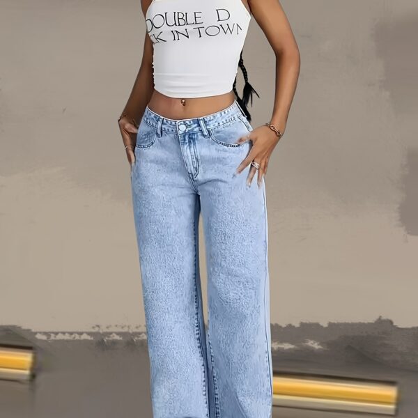 Model wearing Newness Dubai Breeze Wide Leg Jeans a light wash high waisted pair of wide leg jeans
