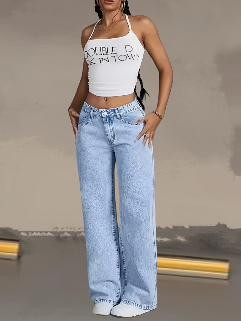 Model wearing Newness Dubai Breeze Wide Leg Jeans, a light wash, high-waisted pair of wide leg jeans.
