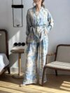 Effortlessly chic Riviera Romance floral print two piece set featuring a long sleeve shirt and wide leg pants perfect for all seasons