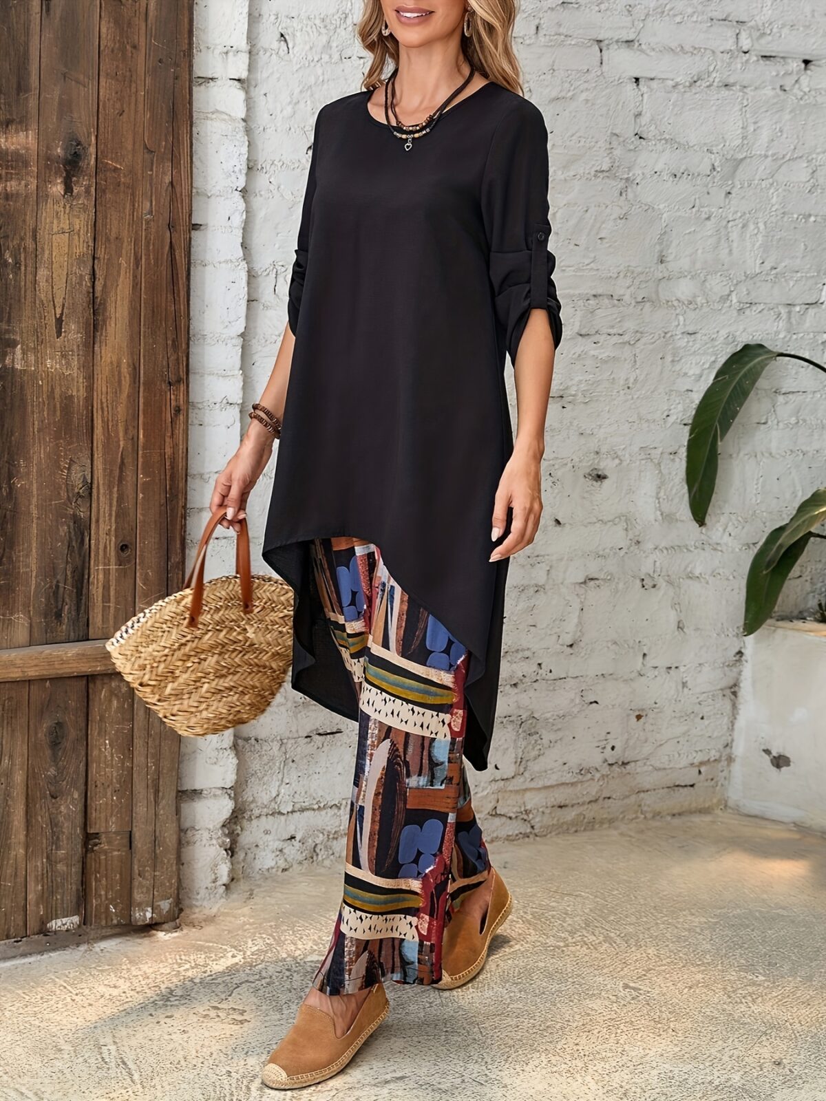 Model showcasing the Newness Casablanca Abstract Print Set a stylish two piece outfit with a solid color top and vibrant abstract print pants