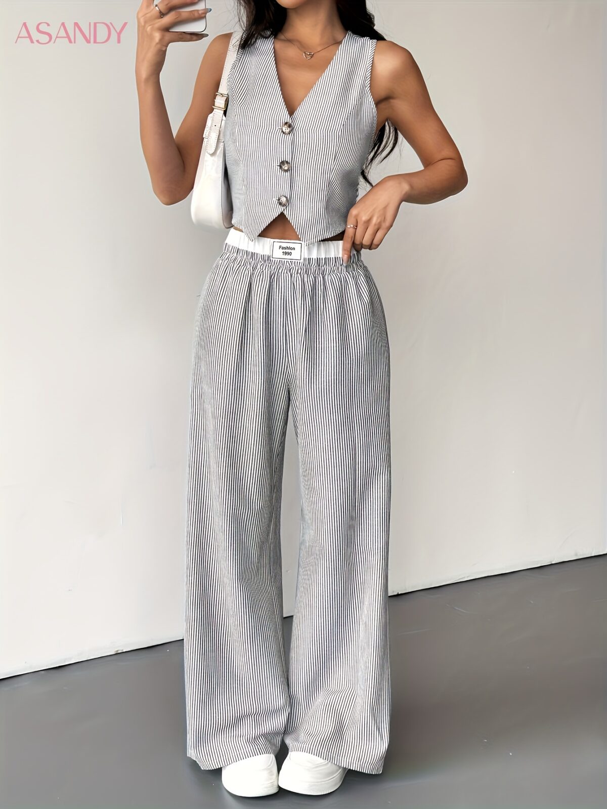 The Newness Riviera Striped Trouser Set in a flattering pose showcasing its relaxed fit and chic style Model is wearing the matching top and trousers