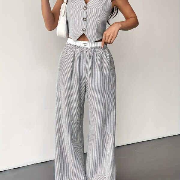 The Newness Riviera Striped Trouser Set in a flattering pose, showcasing its relaxed fit and chic style. Model is wearing the matching top and trousers.