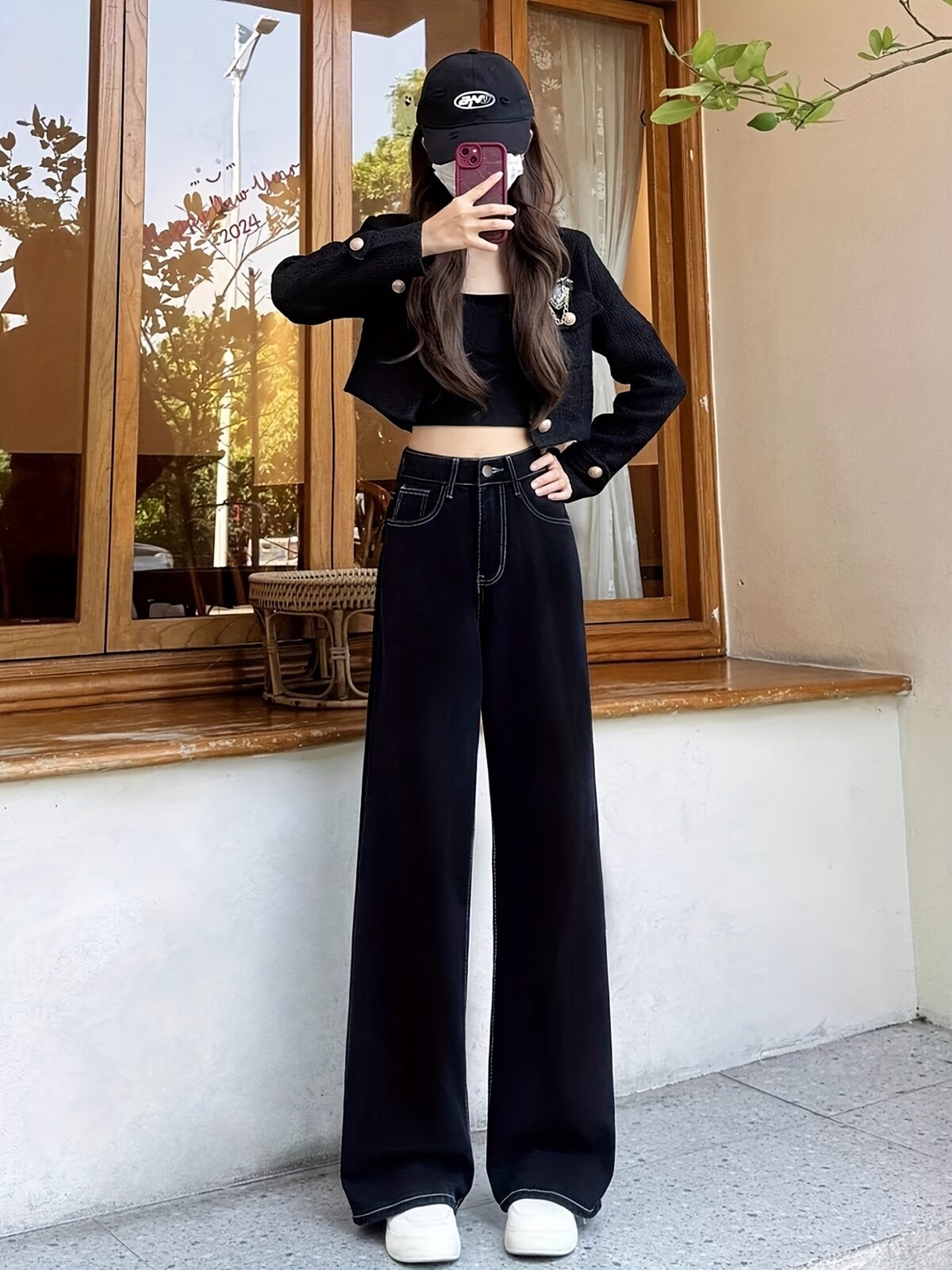 Newness Midnight Hour Black High Waisted Jeans A model showcasing the flattering fit and chic style of the jeans