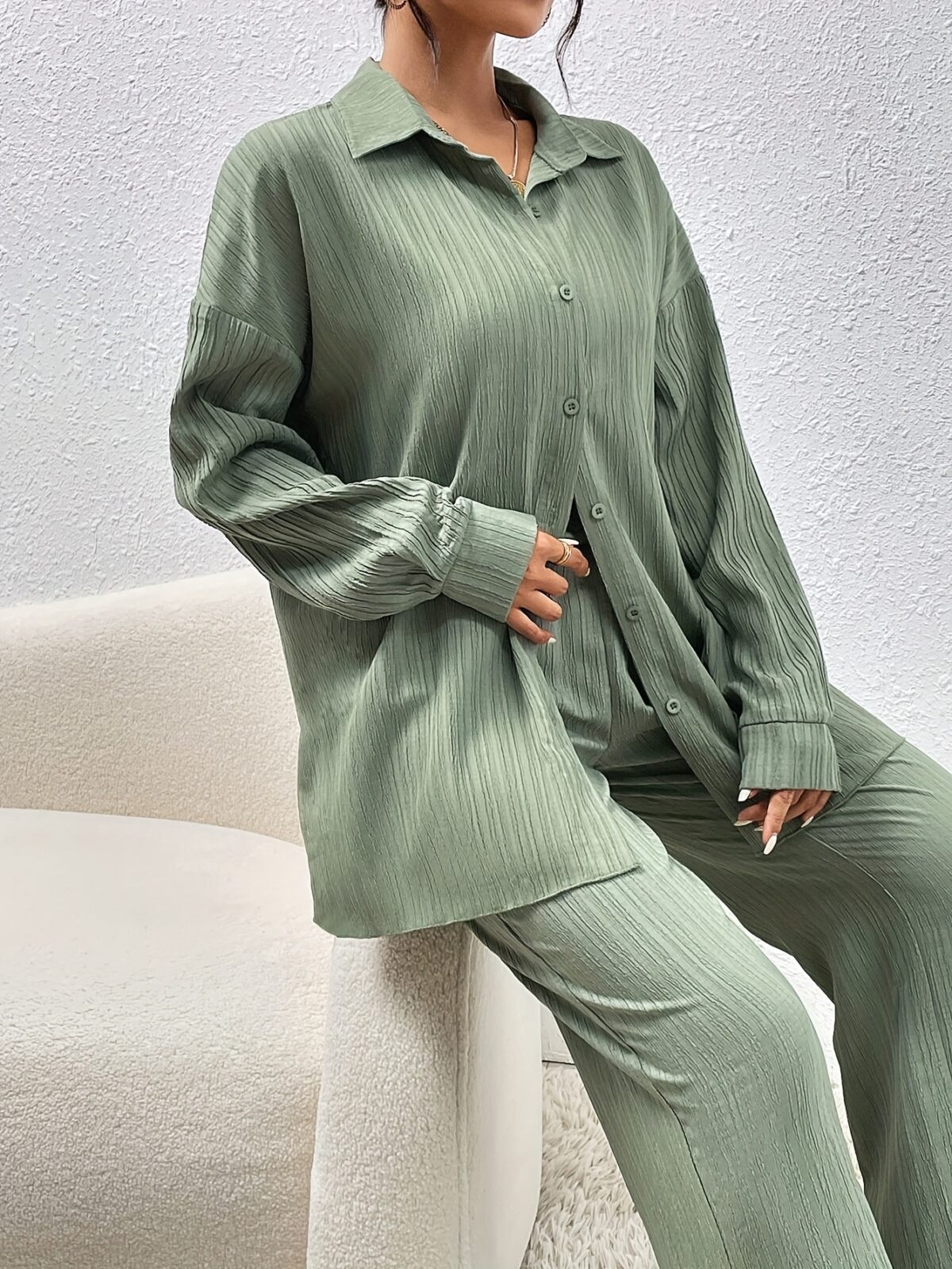 Model wearing the Newness Dubai Nights Off Shoulder Pants Set a luxurious polyester two piece outfit featuring an off shoulder top and wide leg pants perfect for evening events