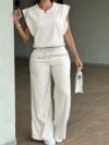 Model wearing the Newness Effortless Chic Sleeveless Wide Leg Set a stylish and comfortable two piece outfit featuring a sleeveless top and wide leg pants in luxurious polyester