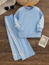 Girl wearing a stylish and comfortable two piece sweatpants set in soft stretchy fabric Perfect for everyday wear