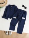 Stylish boys two piece outfit in a trendy striped pattern featuring a comfortable stand collar shirt and cuffed pants perfect for spring or autumn