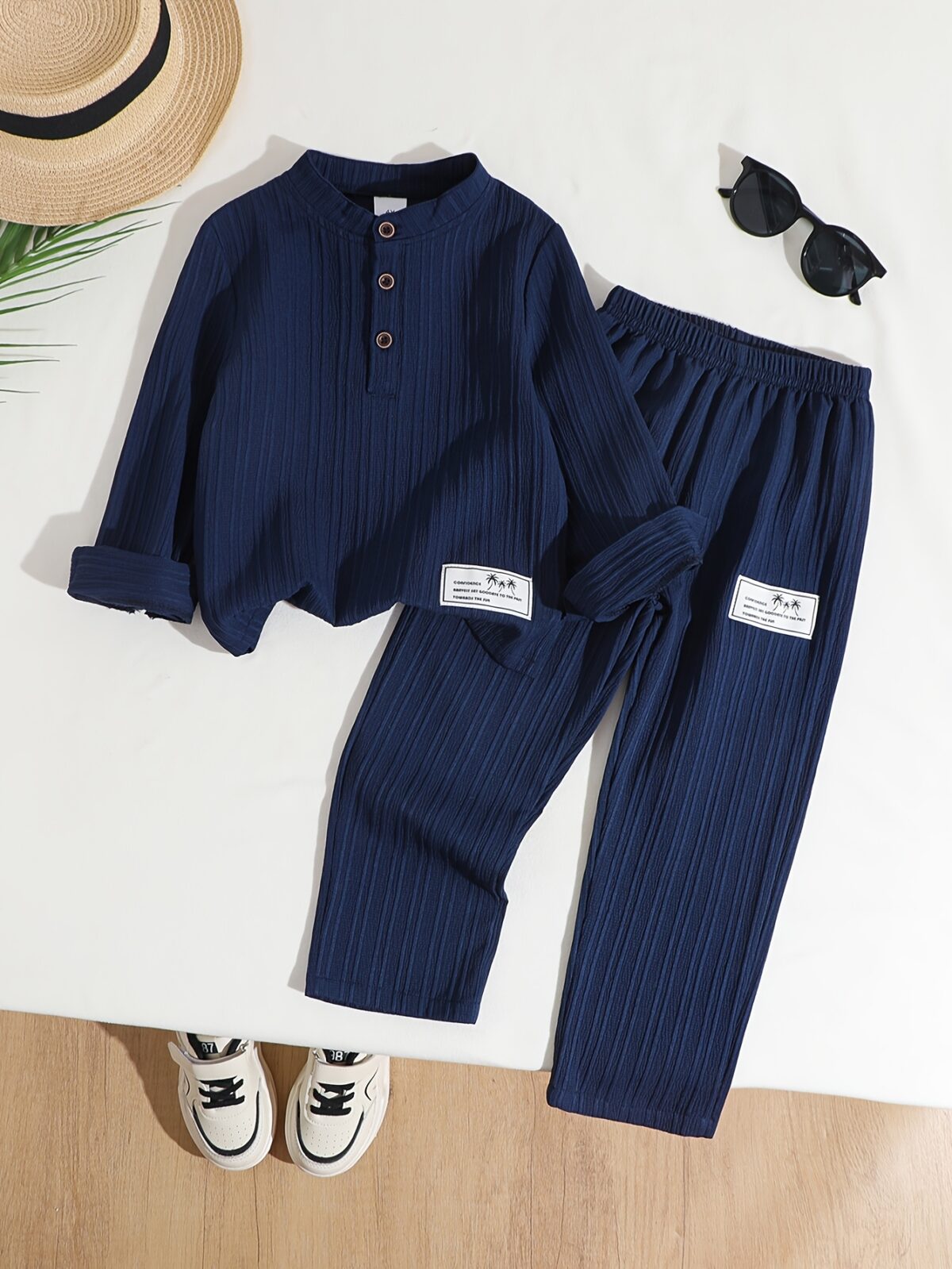 Stylish boys two piece outfit in a trendy striped pattern featuring a comfortable stand collar shirt and cuffed pants perfect for spring or autumn