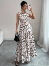 Model wearing the Newness Cairo Nights Geometric Print Dress a chic belted dress perfect for summer featuring a striking geometric print
