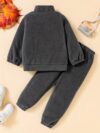Newness Cozy Comfort Boys Winter Fleece Set A stylish and cozy two piece fleece set for boys perfect for keeping warm during winter The image shows a boy wearing the set showcasing its soft fleece fabric and trendy design