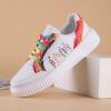 Newness Rainbow Burst Sneakers Chic comfort redefined A pair of vibrant rainbow striped sneakers showcasing their stylish design and comfortable fit